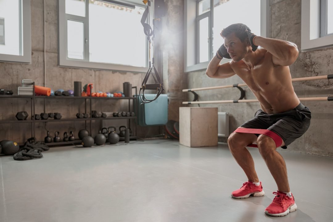 slim strong man doing squat in the gym.jpg
